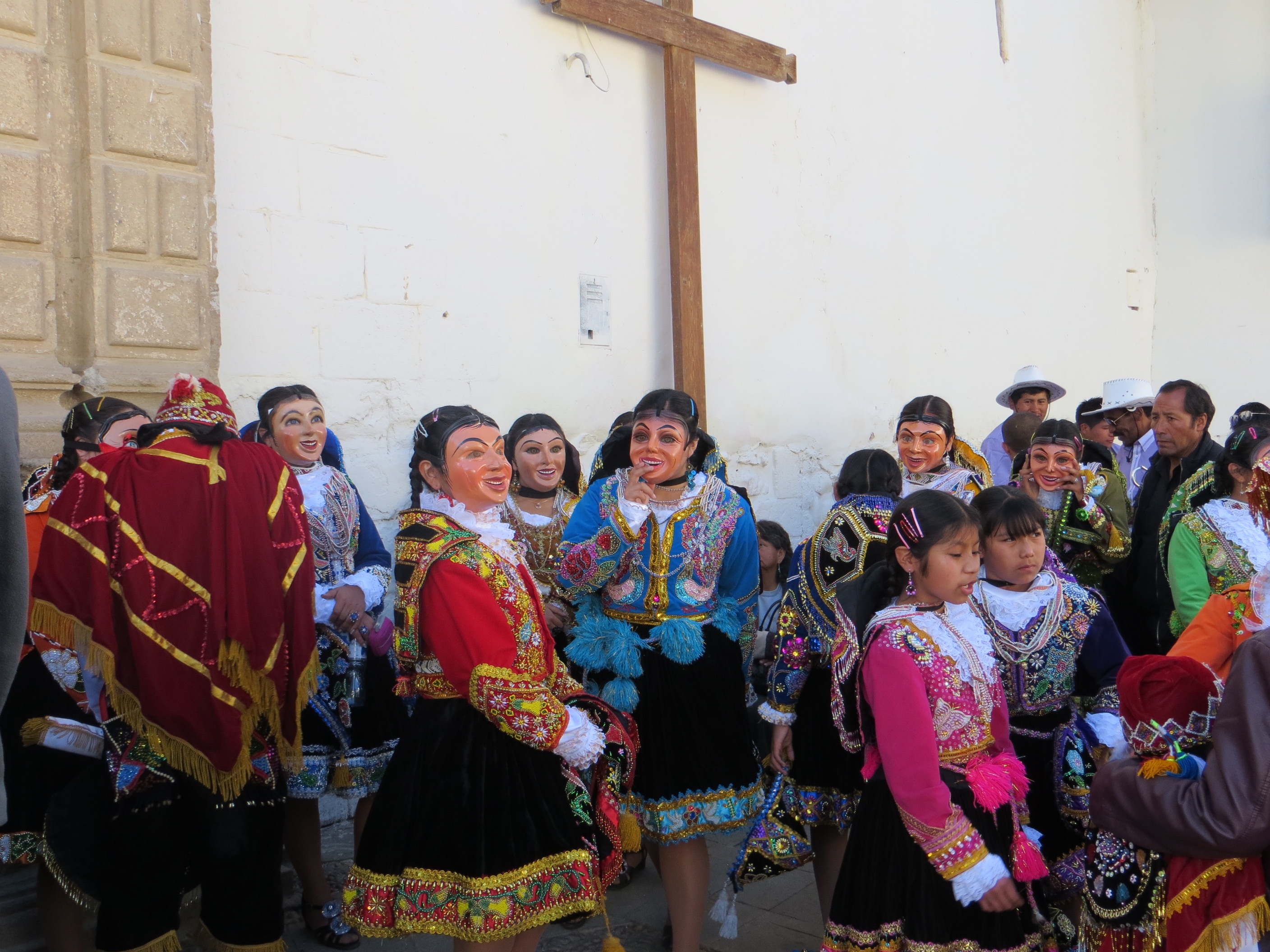 Photo of dancers in full costume and masks waiting to parade as part of the Fiesta de la Virgen del Carmen de Paurcartambo