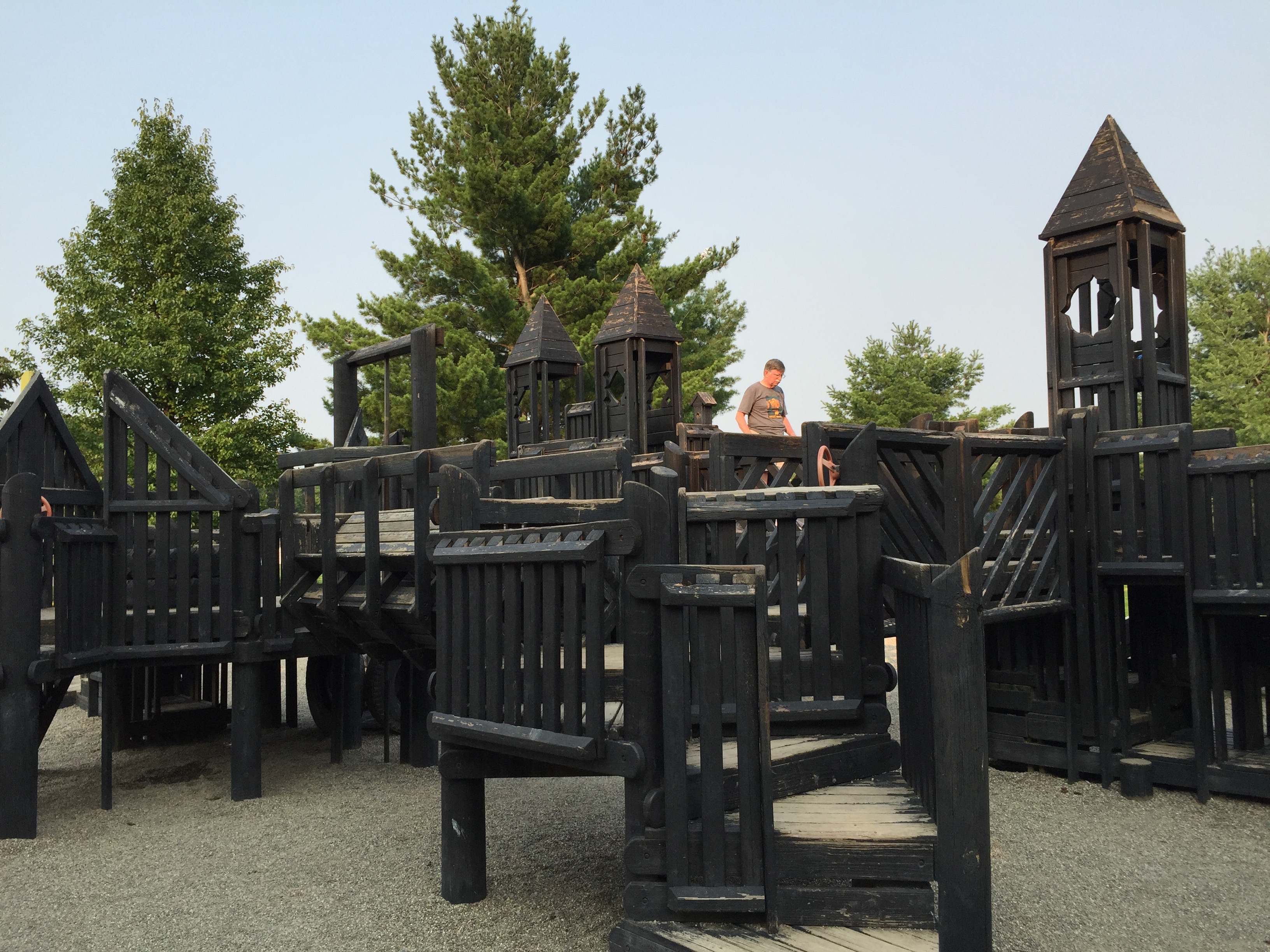 The playground at the Commons. Towers and climbing structures with a castle theme painted black.