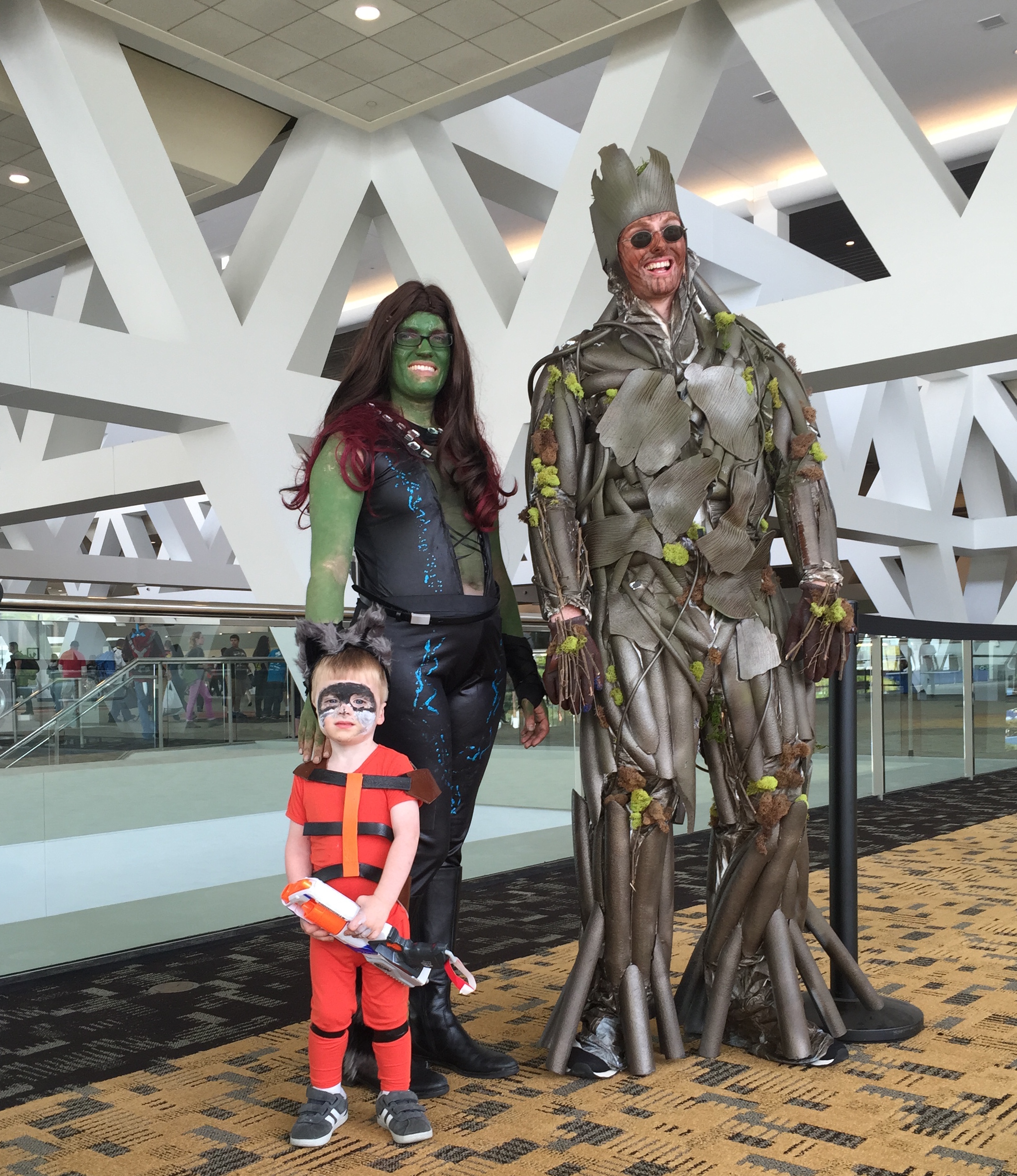 Photo of my family dressed as Groot (my husband), Gamora (me), and Rocket (my two-year-old son)