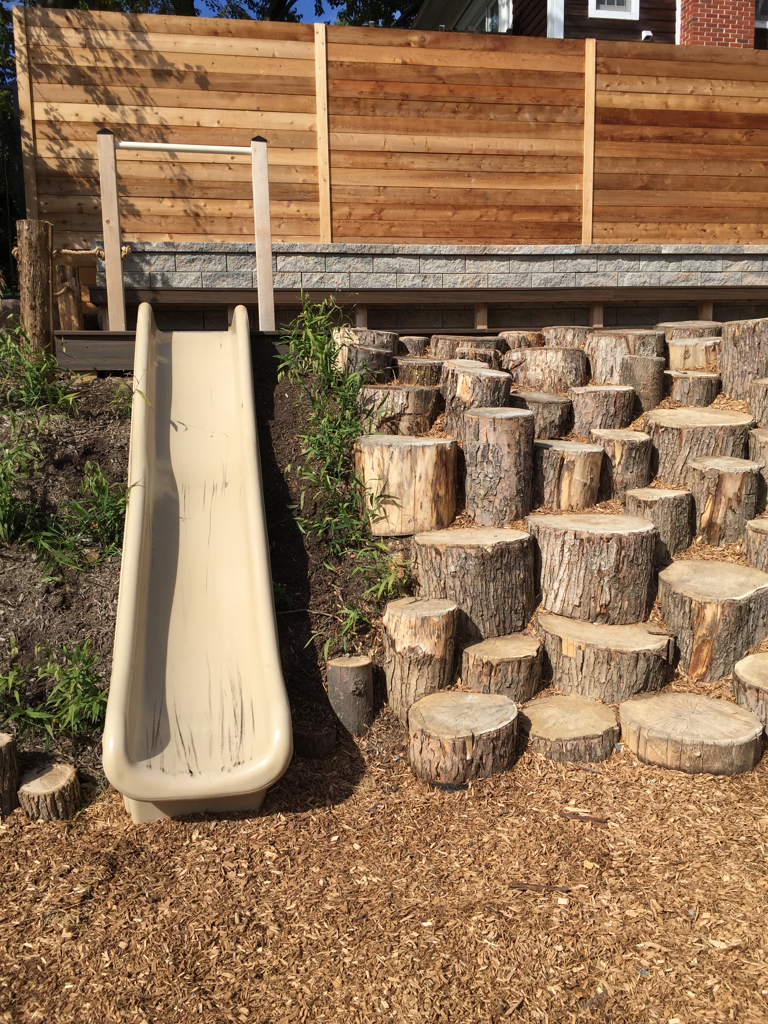 Log sections for climbing next to slide