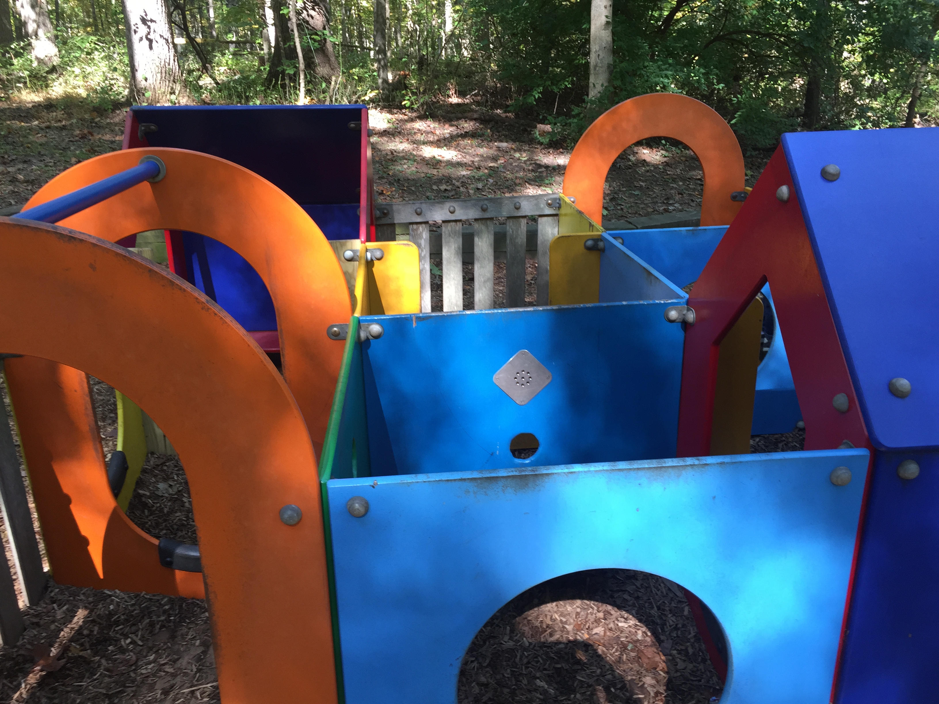 Multi-colored play house at Cabin John park with multiple rooms that kids can crawl between.