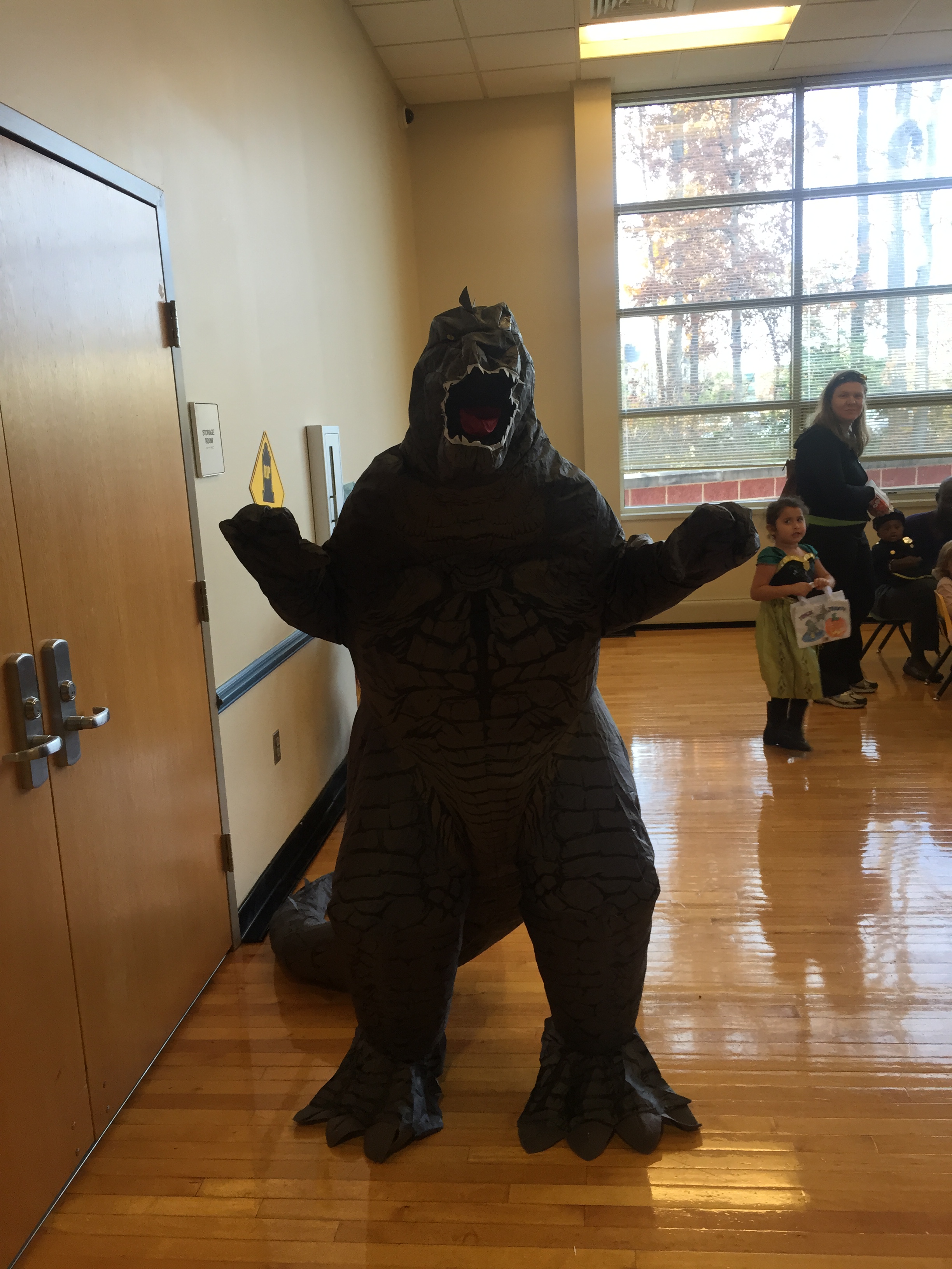 A person in a Godzilla costume