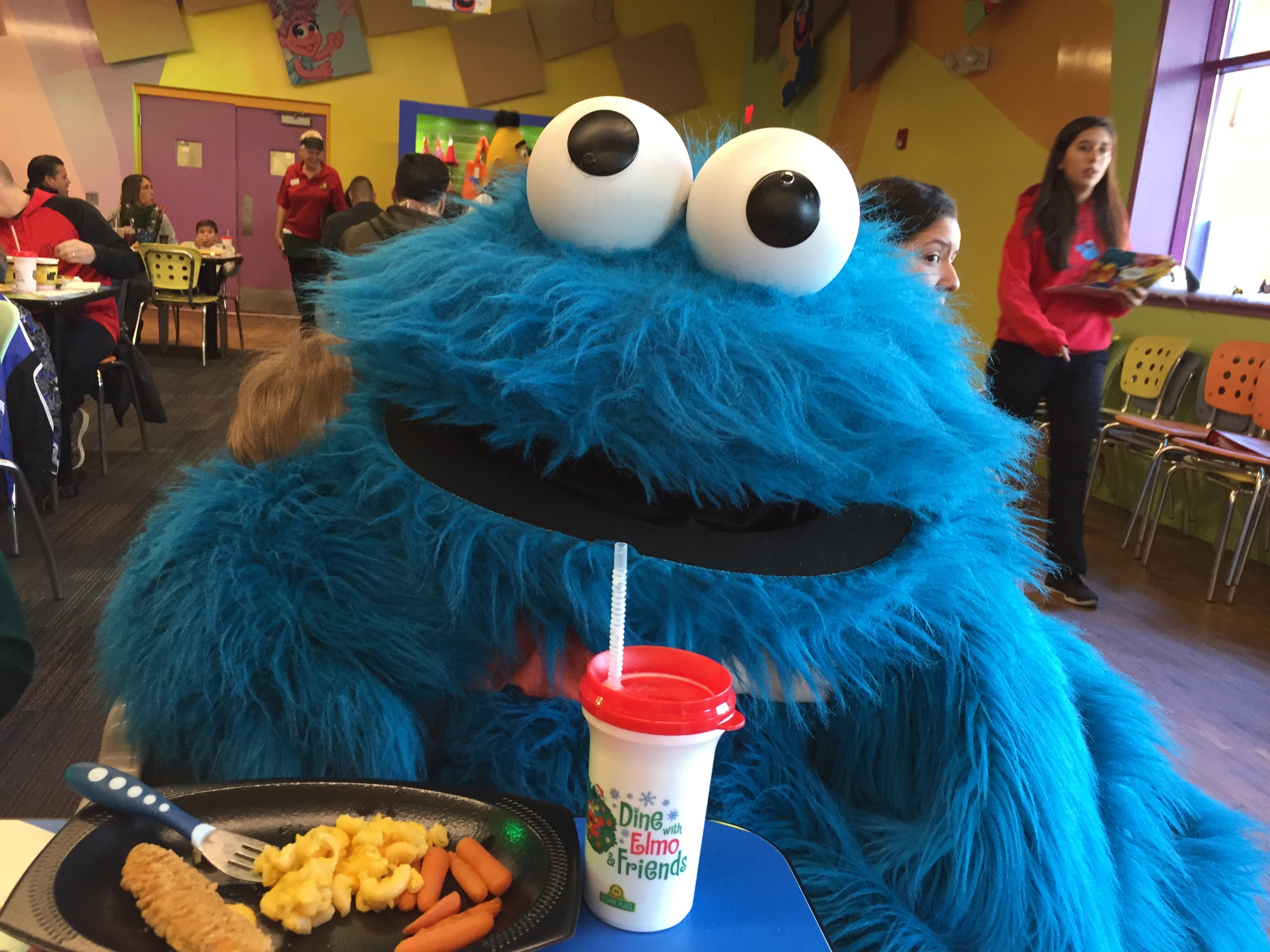 Cookie Monster hugging toddler at Sesame Place